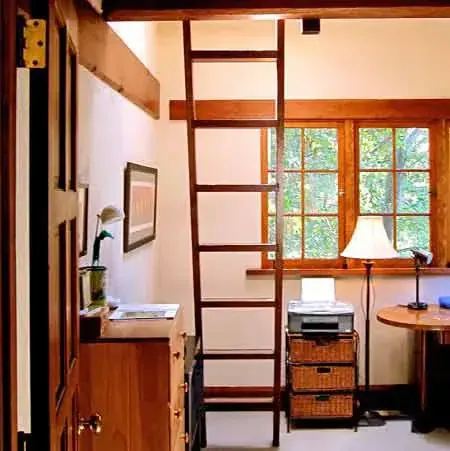 Compact study with handcrafted wood ladder to a sleeping loft