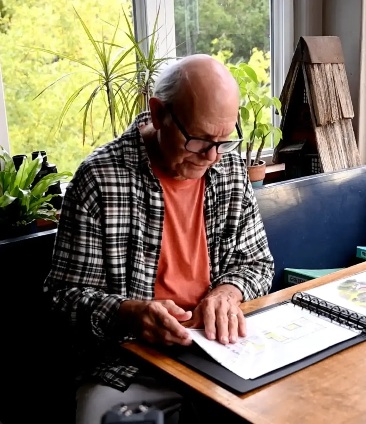 John Kinstle reviewing sketches at his drafting table
